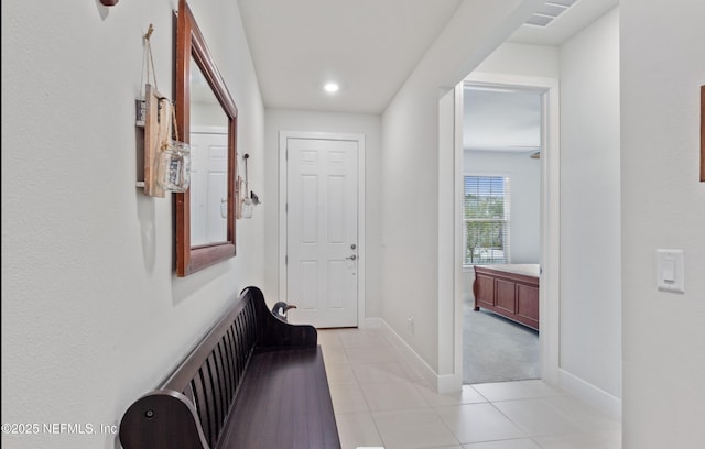 hall with light tile patterned floors