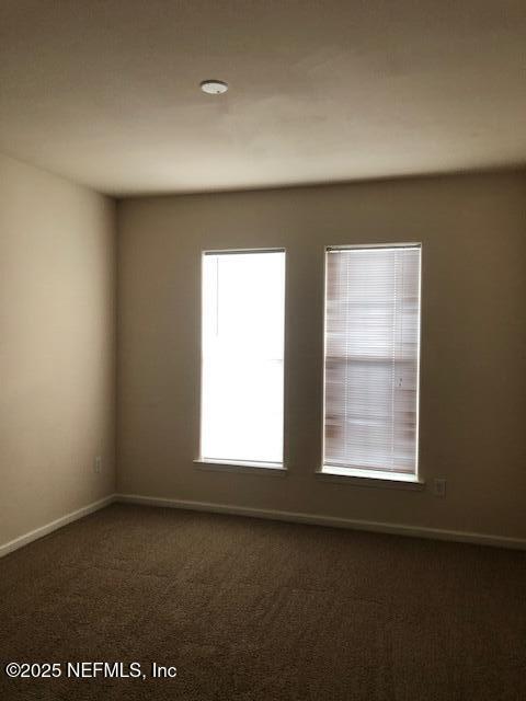 empty room with dark carpet