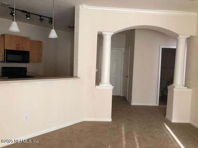 kitchen featuring ornate columns, carpet floors, range, and decorative light fixtures