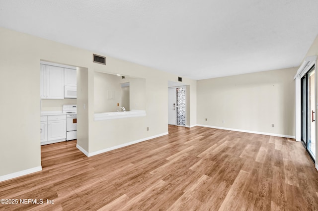 unfurnished living room with light hardwood / wood-style flooring