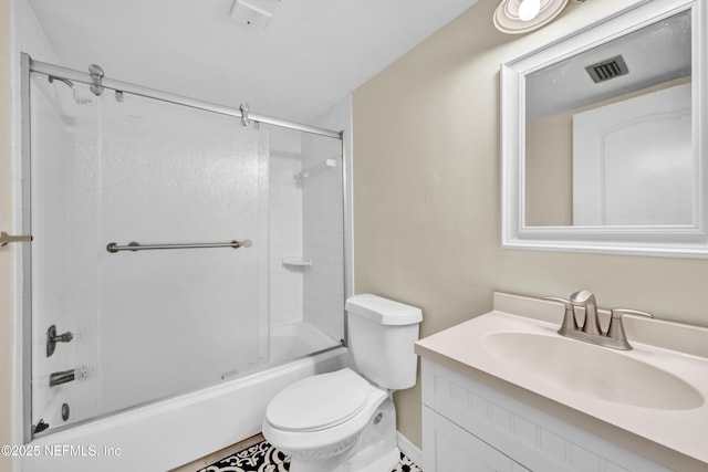 full bathroom with enclosed tub / shower combo, vanity, and toilet