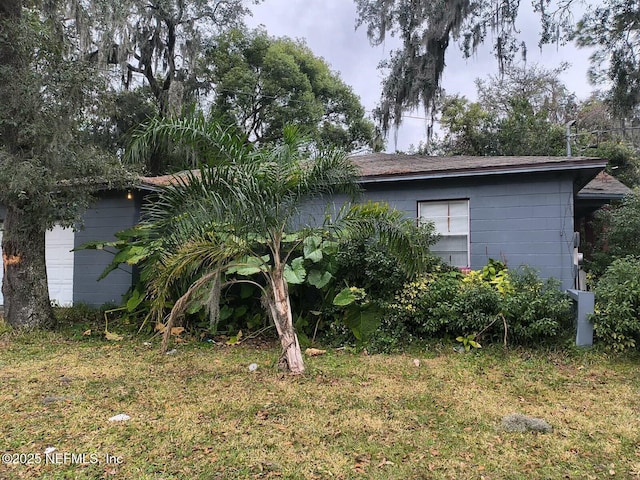 view of side of home featuring a lawn