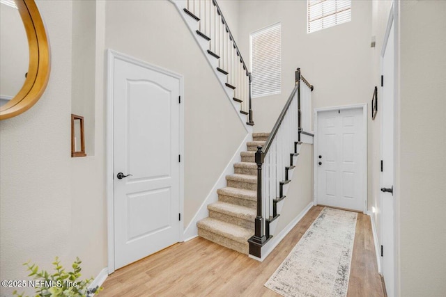 entrance foyer featuring light hardwood / wood-style floors and a high ceiling