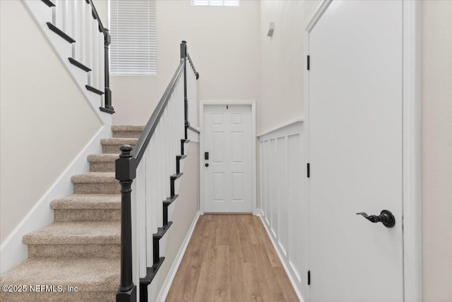 stairs with hardwood / wood-style flooring