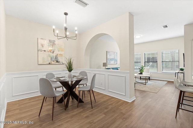 dining room with an inviting chandelier and light wood-type flooring