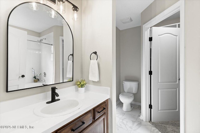 bathroom with toilet, a shower, and vanity