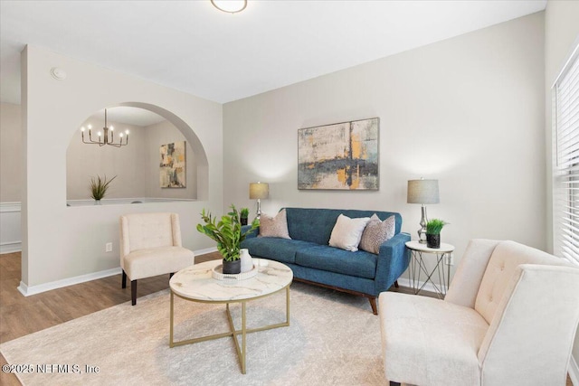 living room featuring a notable chandelier and wood-type flooring