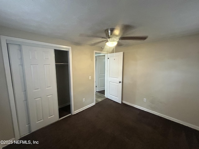 unfurnished bedroom with ceiling fan and a closet