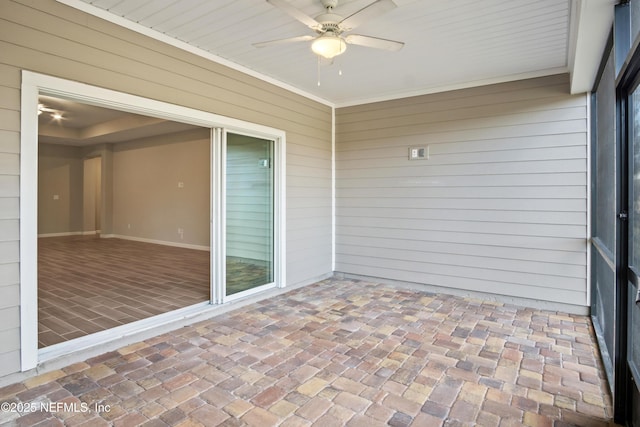 unfurnished sunroom featuring ceiling fan