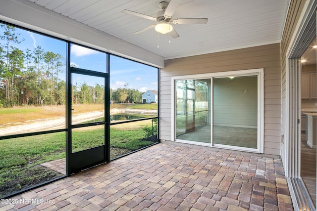 unfurnished sunroom with ceiling fan