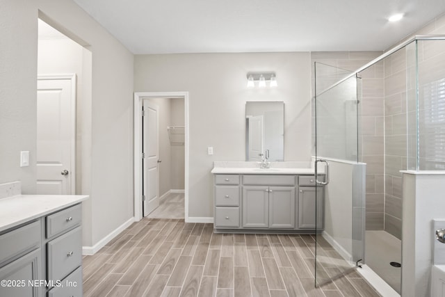 bathroom with an enclosed shower and vanity