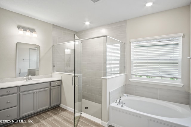 bathroom with vanity and plus walk in shower