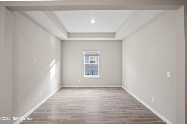 empty room featuring a tray ceiling