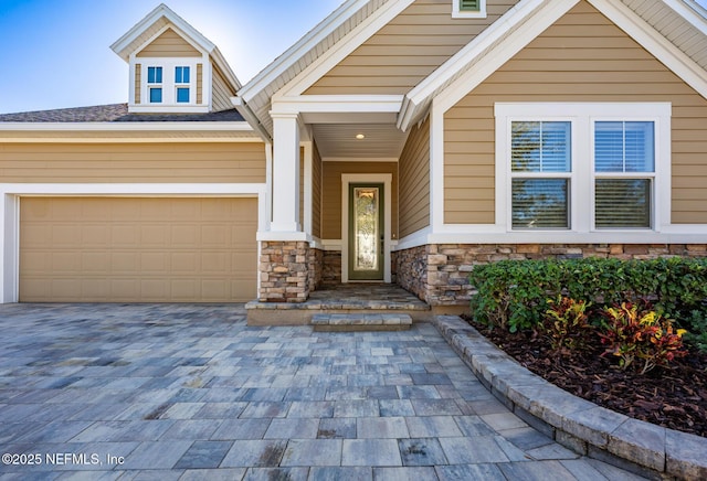 doorway to property with a garage