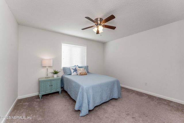 bedroom featuring a textured ceiling, ceiling fan, and carpet floors