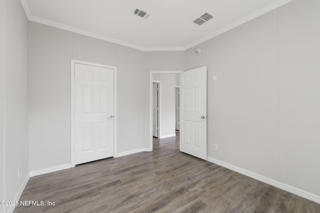 unfurnished bedroom with ornamental molding and dark hardwood / wood-style flooring