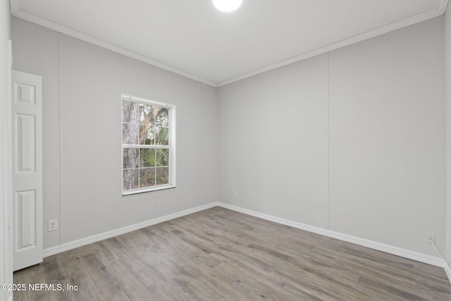 spare room featuring ornamental molding and hardwood / wood-style flooring