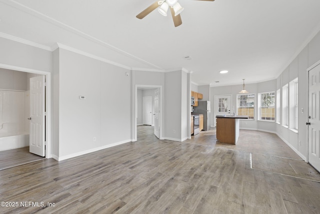 unfurnished living room with ceiling fan, ornamental molding, and light hardwood / wood-style flooring