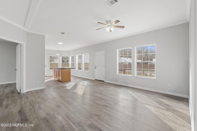 unfurnished living room with ceiling fan, light hardwood / wood-style floors, and crown molding