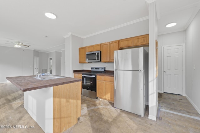 kitchen featuring stainless steel appliances, a center island with sink, ornamental molding, ceiling fan, and sink