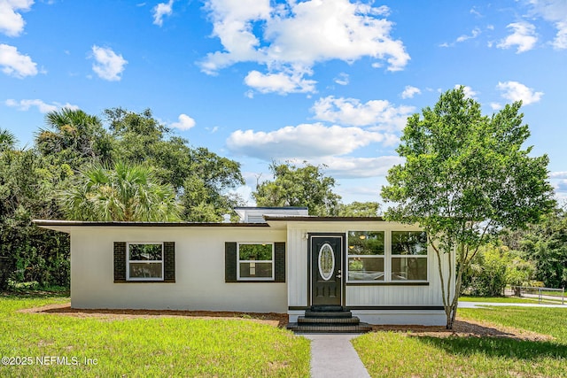 ranch-style house with a front lawn