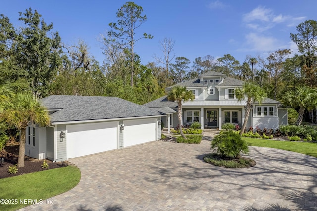 view of front of home with covered porch and a garage