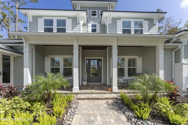 entrance to property featuring covered porch