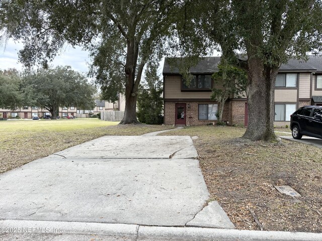 7020 Prestwick Cir N, Jacksonville, FL 32244 - view of front of home featuring brick siding and a front lawn