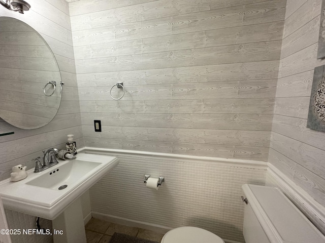 7020 Prestwick Cir N, Jacksonville, FL 32244 - half bath with wood walls, toilet, and a sink