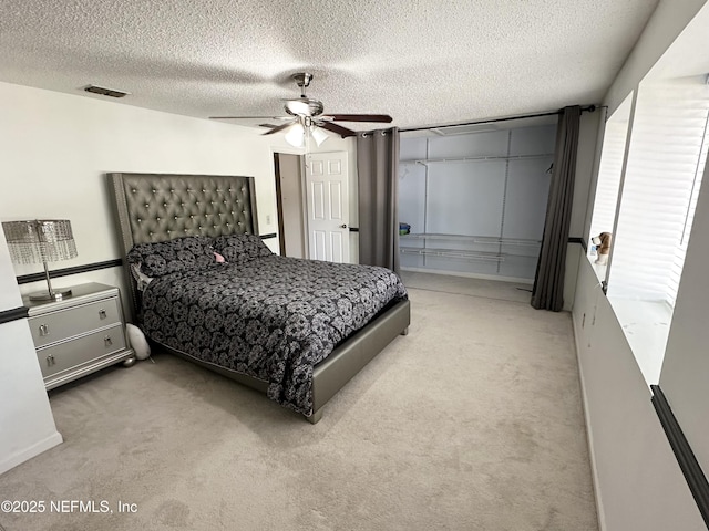 7020 Prestwick Cir N, Jacksonville, FL 32244 - bedroom with visible vents, light colored carpet, a ceiling fan, and a textured ceiling
