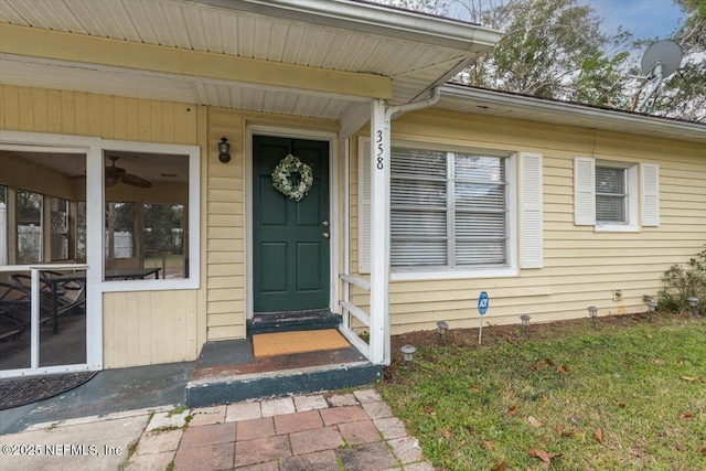 doorway to property with a lawn