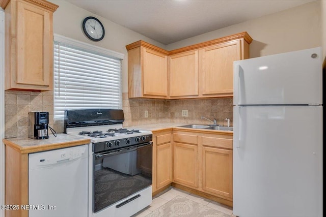 kitchen featuring white appliances, light tile patterned floors, light brown cabinets, sink, and tasteful backsplash