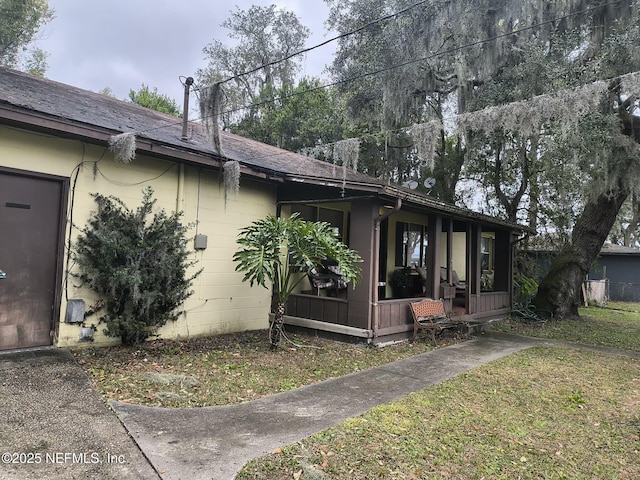 view of side of property with a yard