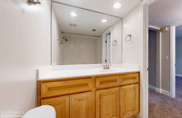 bathroom with vanity and a textured ceiling