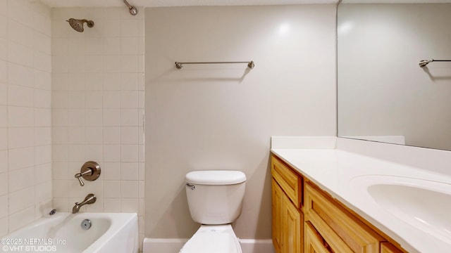 full bathroom with toilet, vanity, and tiled shower / bath