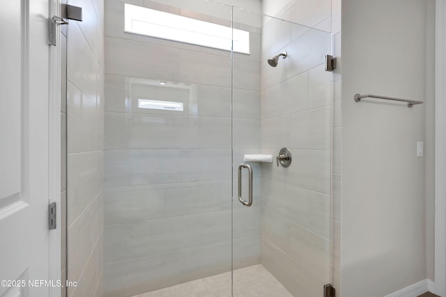 bathroom featuring a shower with door