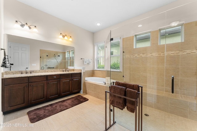 bathroom featuring vanity, independent shower and bath, and tile patterned flooring