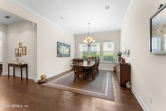 dining area featuring a chandelier, crown molding, and dark hardwood / wood-style floors