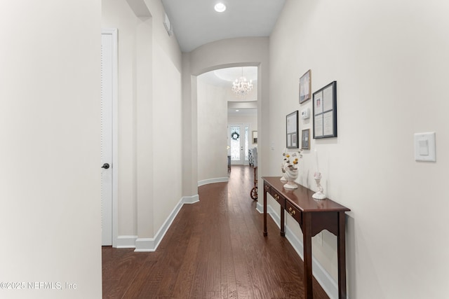 corridor featuring dark hardwood / wood-style flooring and a notable chandelier