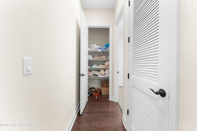 corridor with dark hardwood / wood-style floors