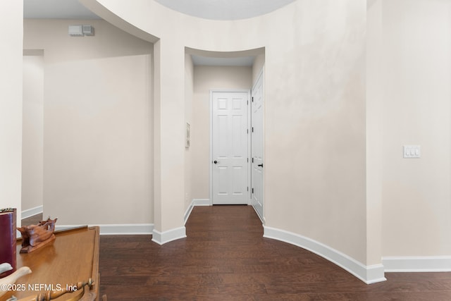 hallway with dark wood-type flooring