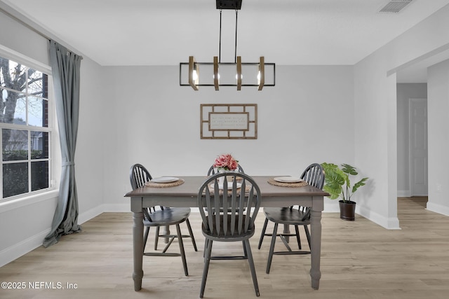 dining room featuring a chandelier and light hardwood / wood-style floors