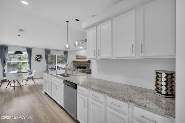 kitchen with sink, decorative light fixtures, white cabinetry, and dishwasher