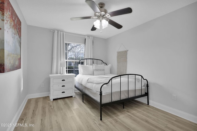 bedroom with ceiling fan and light hardwood / wood-style floors