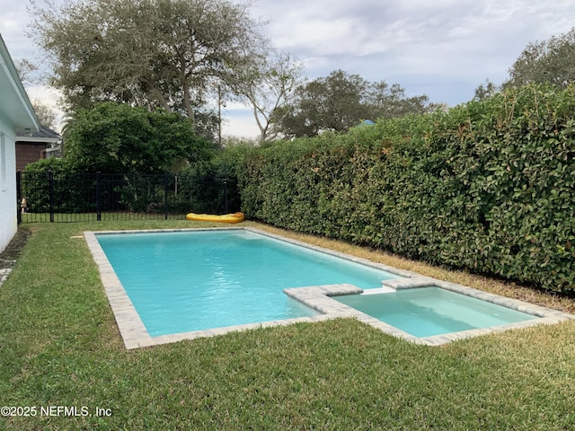 view of swimming pool with a yard