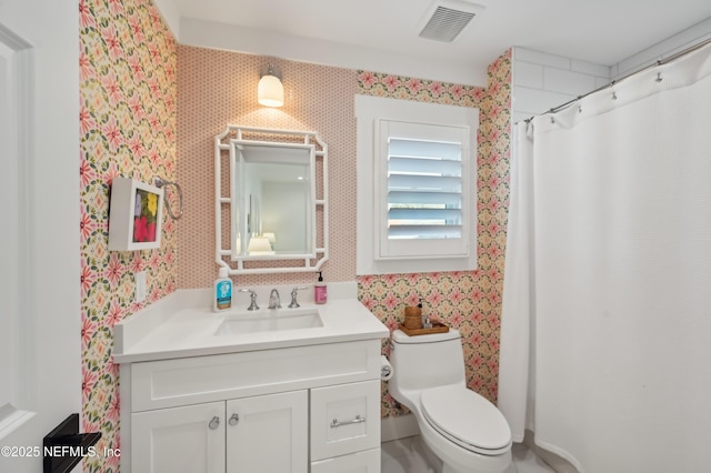 bathroom featuring vanity and toilet