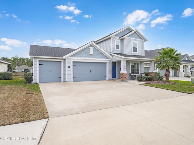 craftsman-style home featuring a front yard and a garage