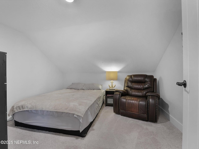 carpeted bedroom featuring lofted ceiling