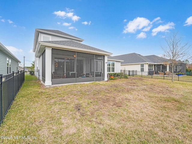 back of property with a sunroom and a yard