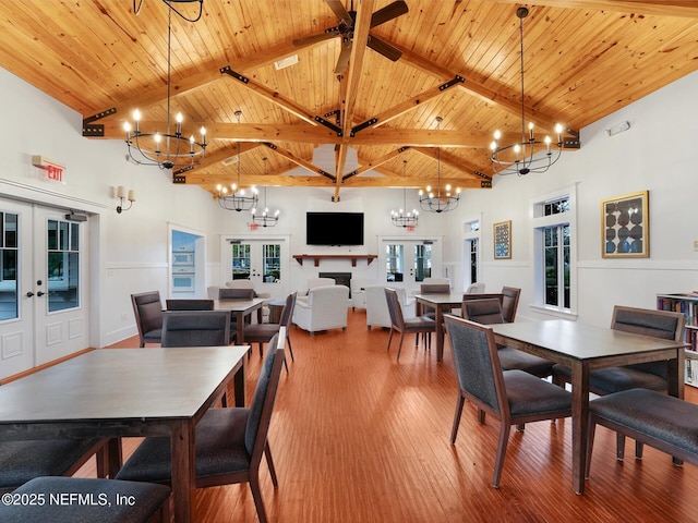 dining room featuring high vaulted ceiling, french doors, wood ceiling, and beamed ceiling